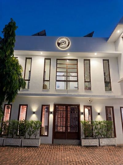 UHF & Co. office at night with illuminated branded signage, Gulberg, Lahore